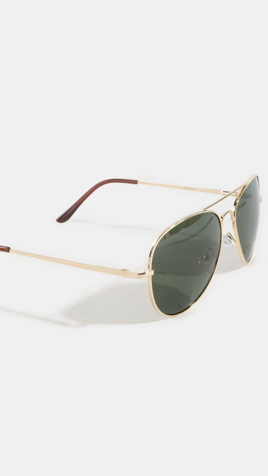 Gold-framed sunglasses with green lenses on a light gray background