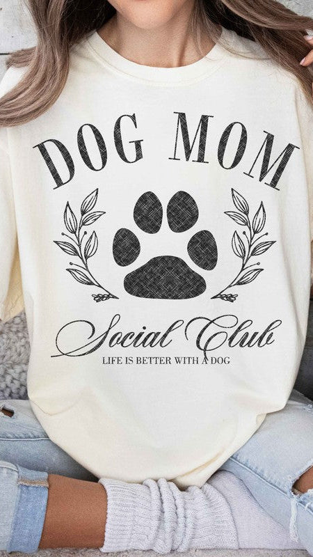 Natural colored Graphic short-sleeved T-shirt on a model that reads "Dog Mom Socal Club".
