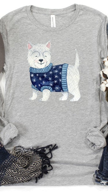 White Scottie dog wearing a blue holiday sweater on gray long-sleeve. Shop The House of Blondie.